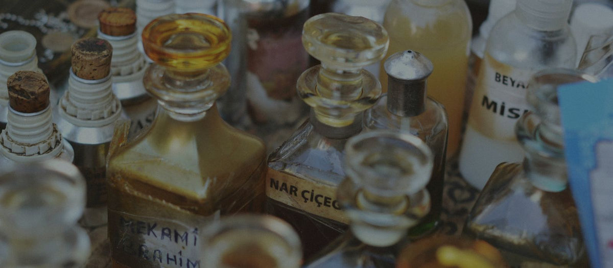 Perfume bottles with glass stoppers on a wooden counter