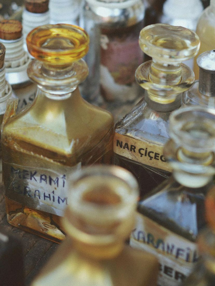 Perfume bottles with glass stoppers on a wooden counter